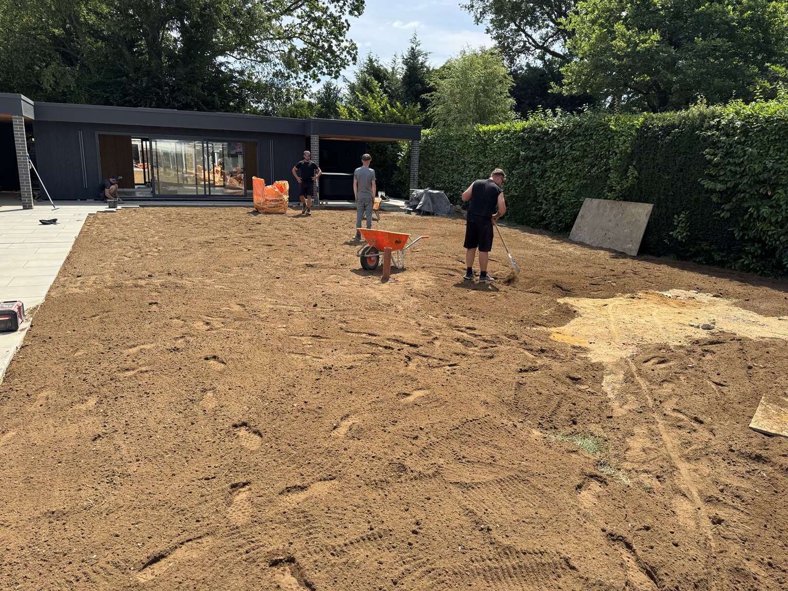 Team preparing and levelling soil for the lawn